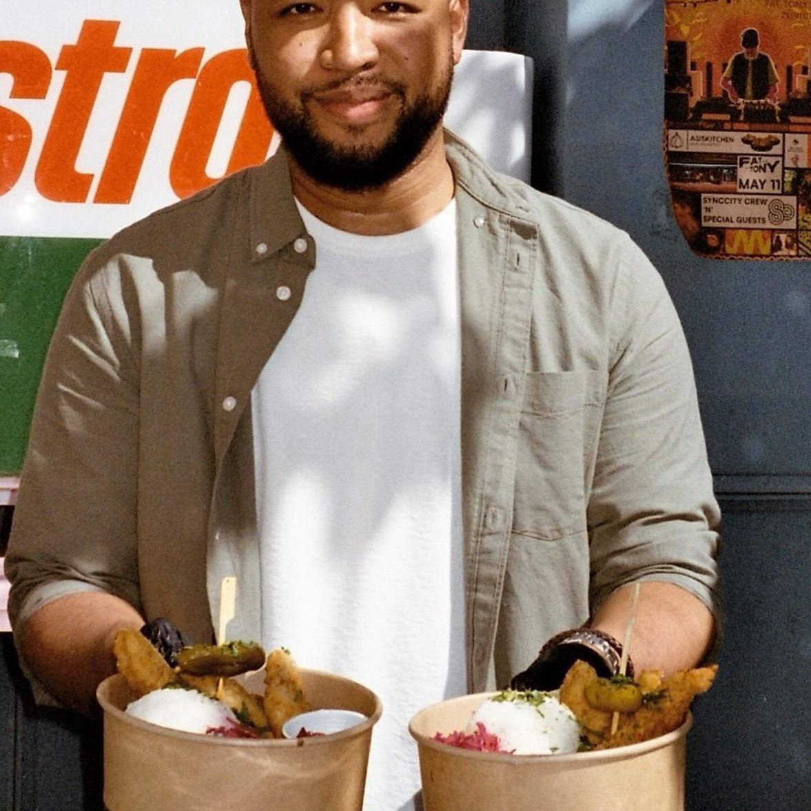 Male person holding bowls of chicken